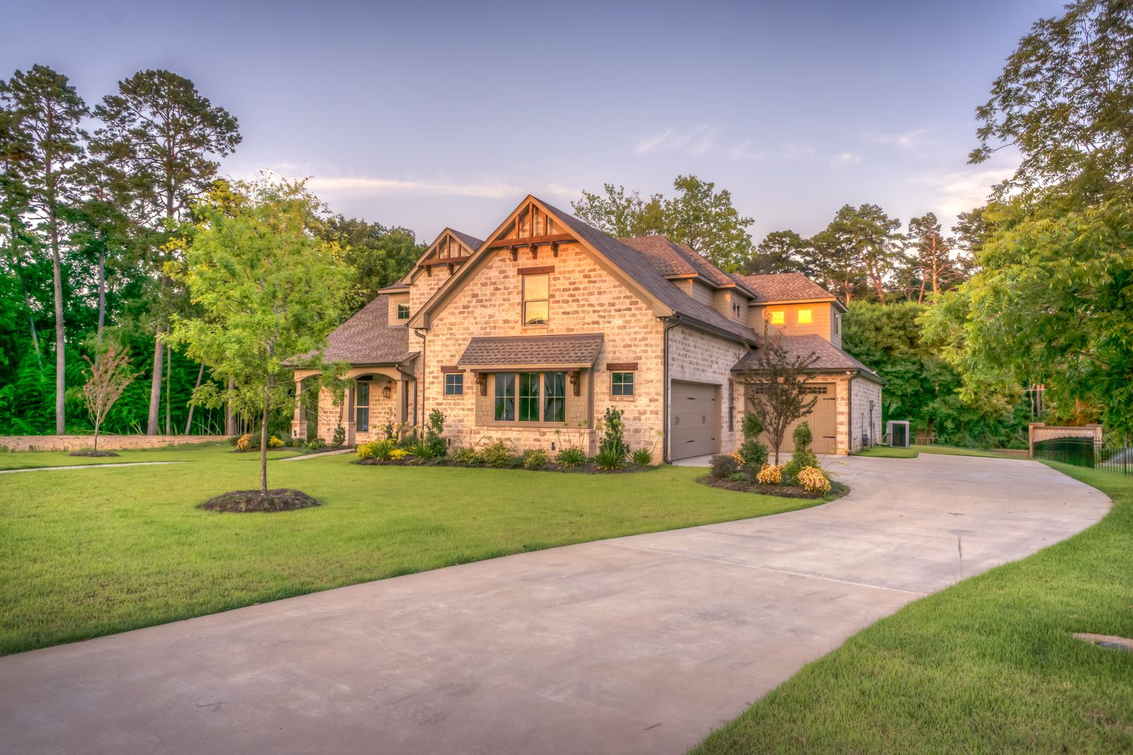 A wide, well-kept lawn wrapping around a house